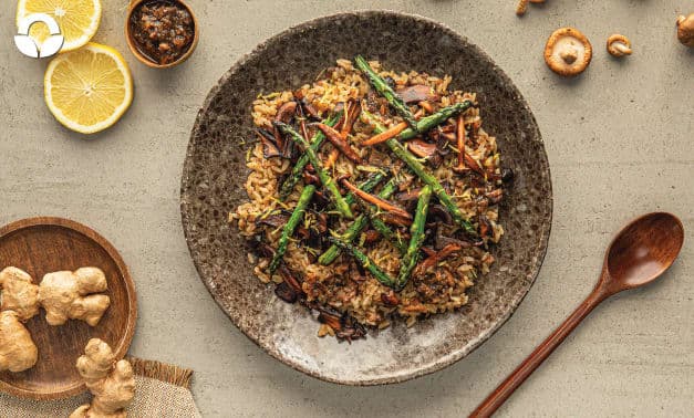 A plate of rice with asparagus and mushrooms