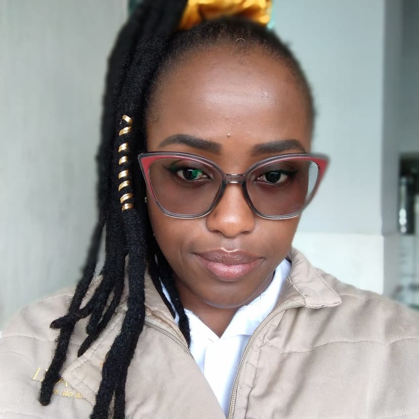 A woman wearing glasses and a ponytail with a bow on top of her head