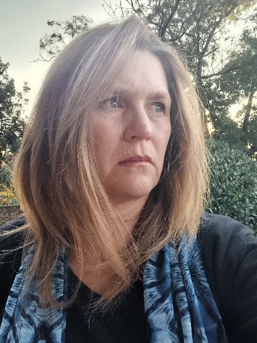 A woman with a blue scarf around her neck