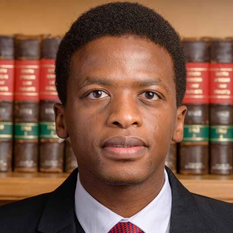 A close up of a person wearing a suit and tie