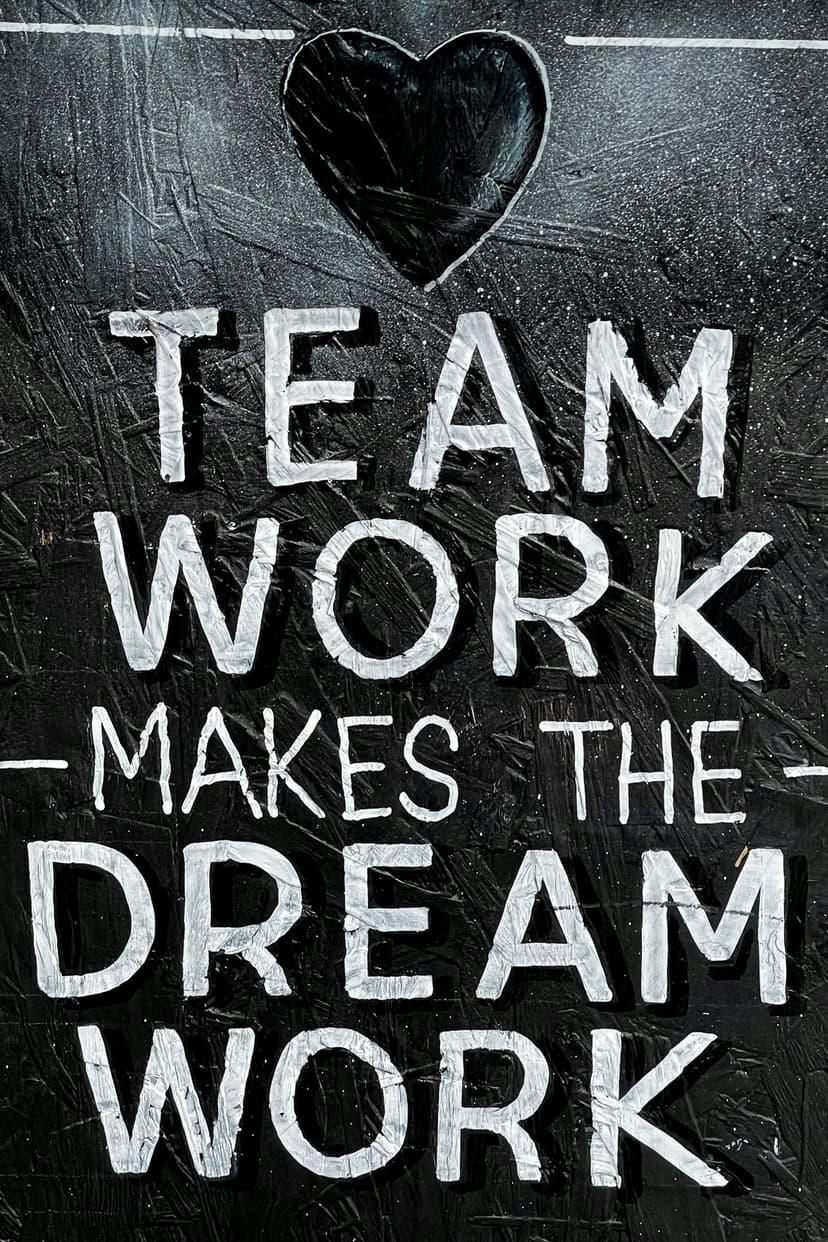 A black and white poster with the words team work makes the dream work