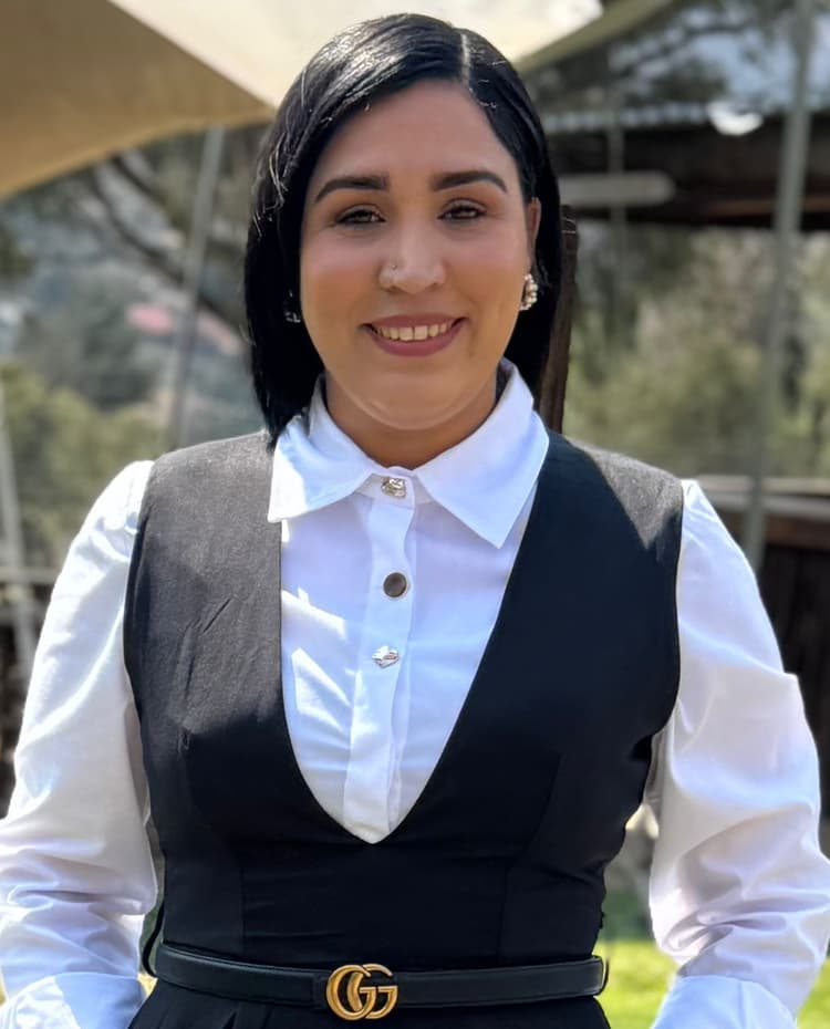 A woman wearing a black dress and a white shirt