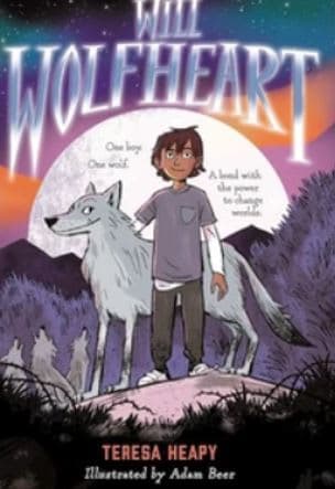 A young boy standing next to a wolf